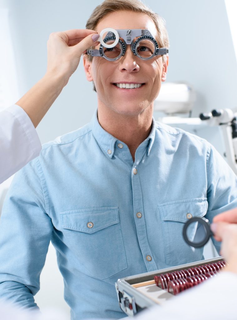 ophthalmologist-examining-middle-aged-man-eyes-with-trial-frame-and-lenses.jpg